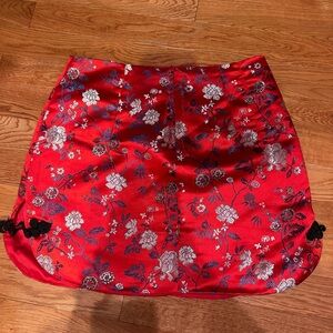 red satin mini skirt with embroidered flowers